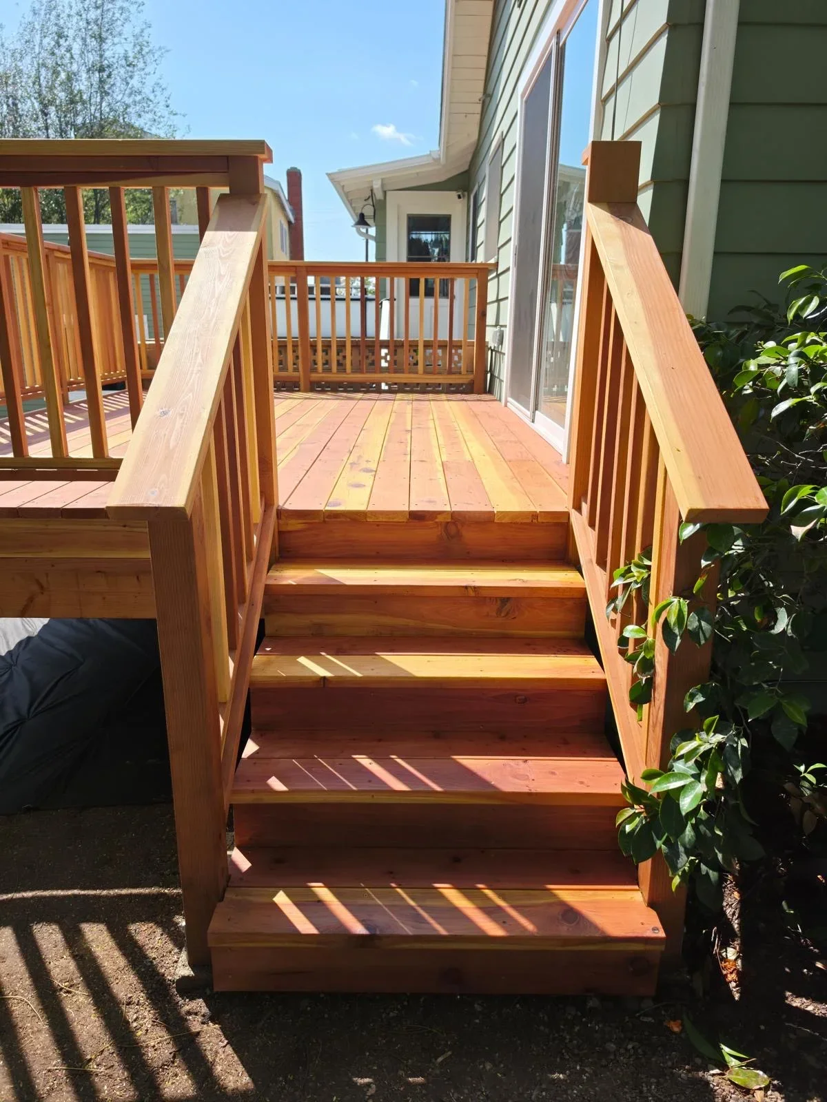 Cedar deck with wooden stairs and railings leading to multi-level platform